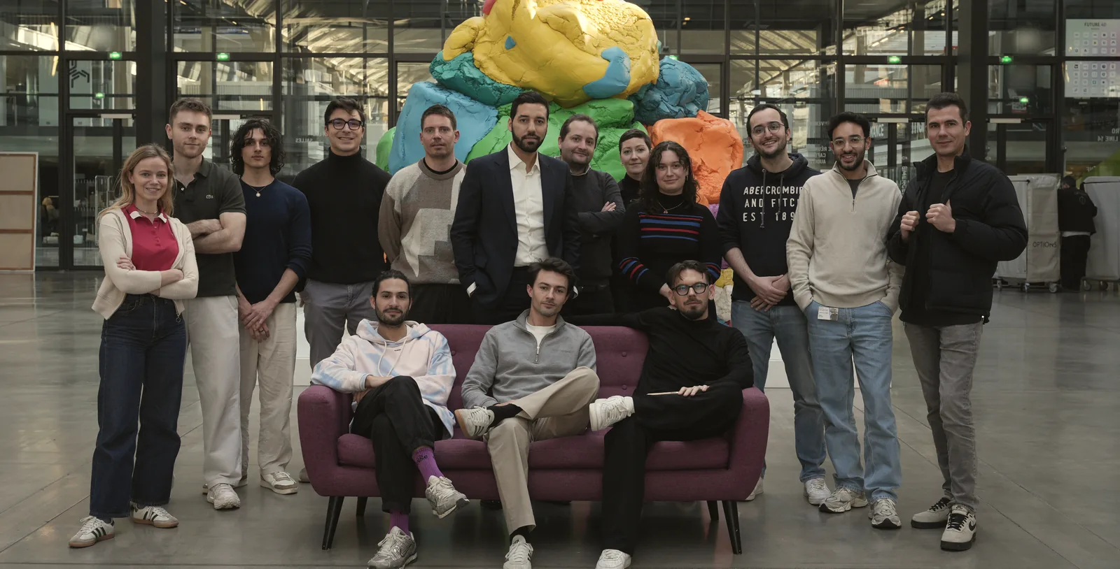 The AlloBrain team gathered around a sofa in Paris